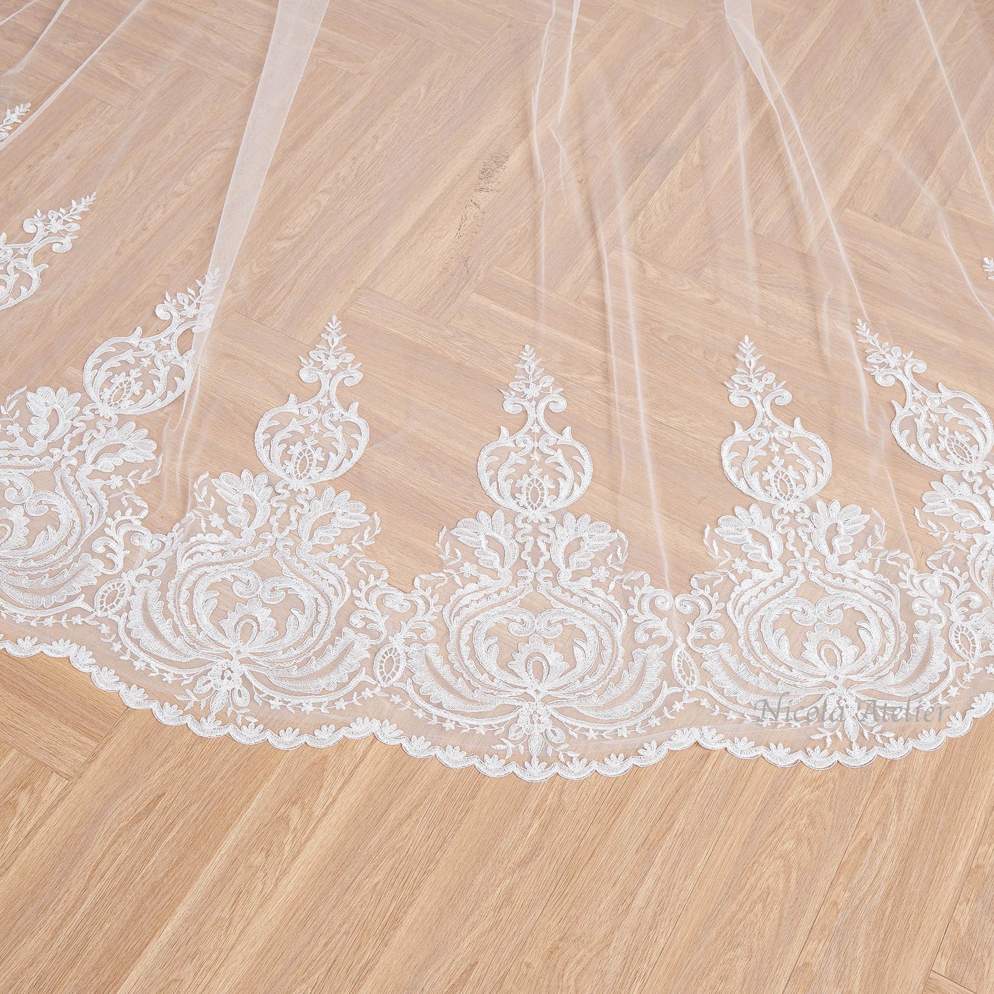 Close-up of corded lace border with hand-sewn clear sequins on tulle Nicola Xu Atelier.