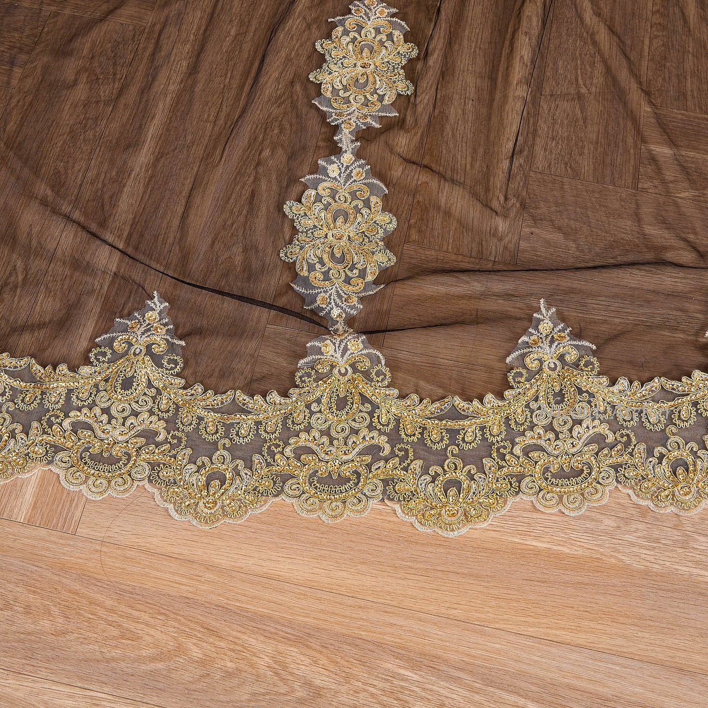 Detailed view of gold lace center extension meeting the bottom border on black tulle Nicola Xu Atelier
