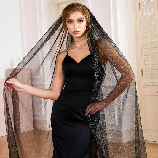 Bride holding a single-tier black sheer veil with silver sparkles in a classic room by Nicola Xu Atelier.