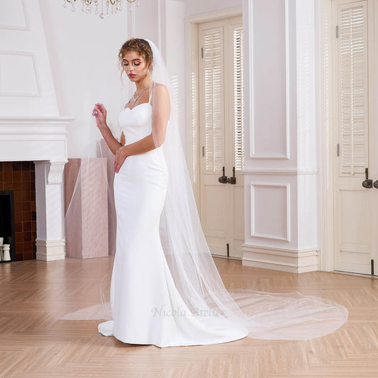 Bride in mermaid gown with 3m sheer cathedral veil, indoor ceremony setting,