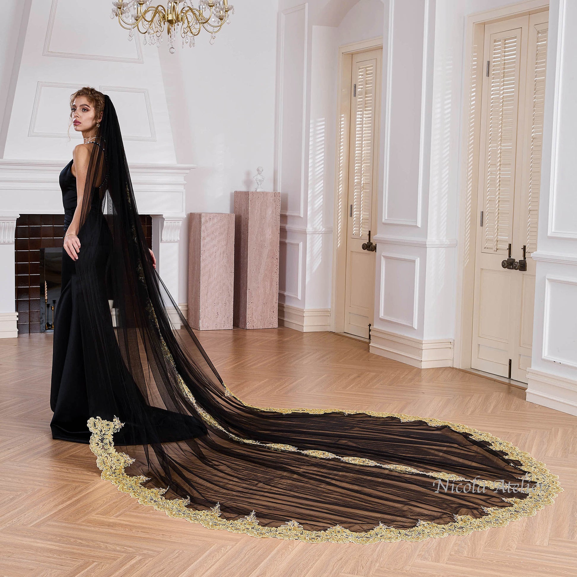 Bride wearing sheer black tulle veil draped over shoulders in indoor venue Nicola Xu Atelier