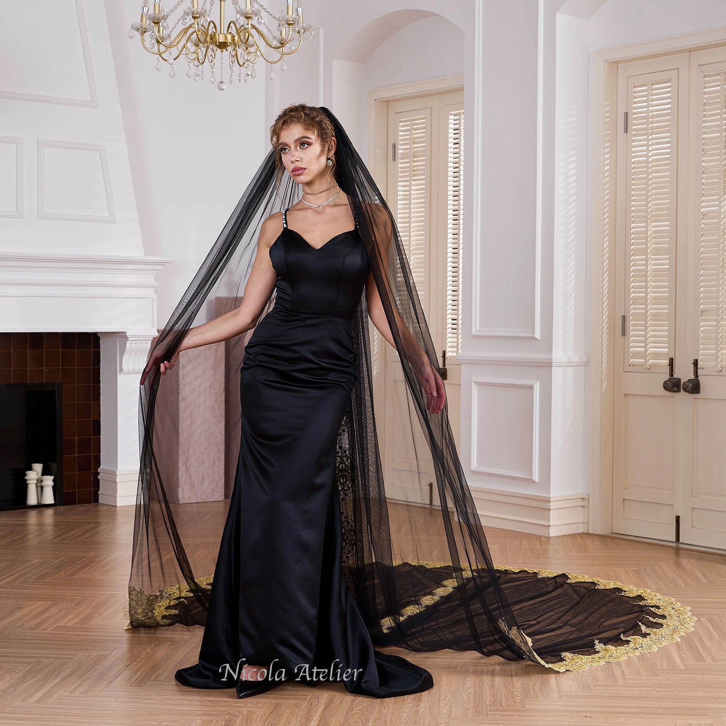 Bride wearing sheer black tulle veil draped over shoulders in indoor venue Nicola Xu Atelier