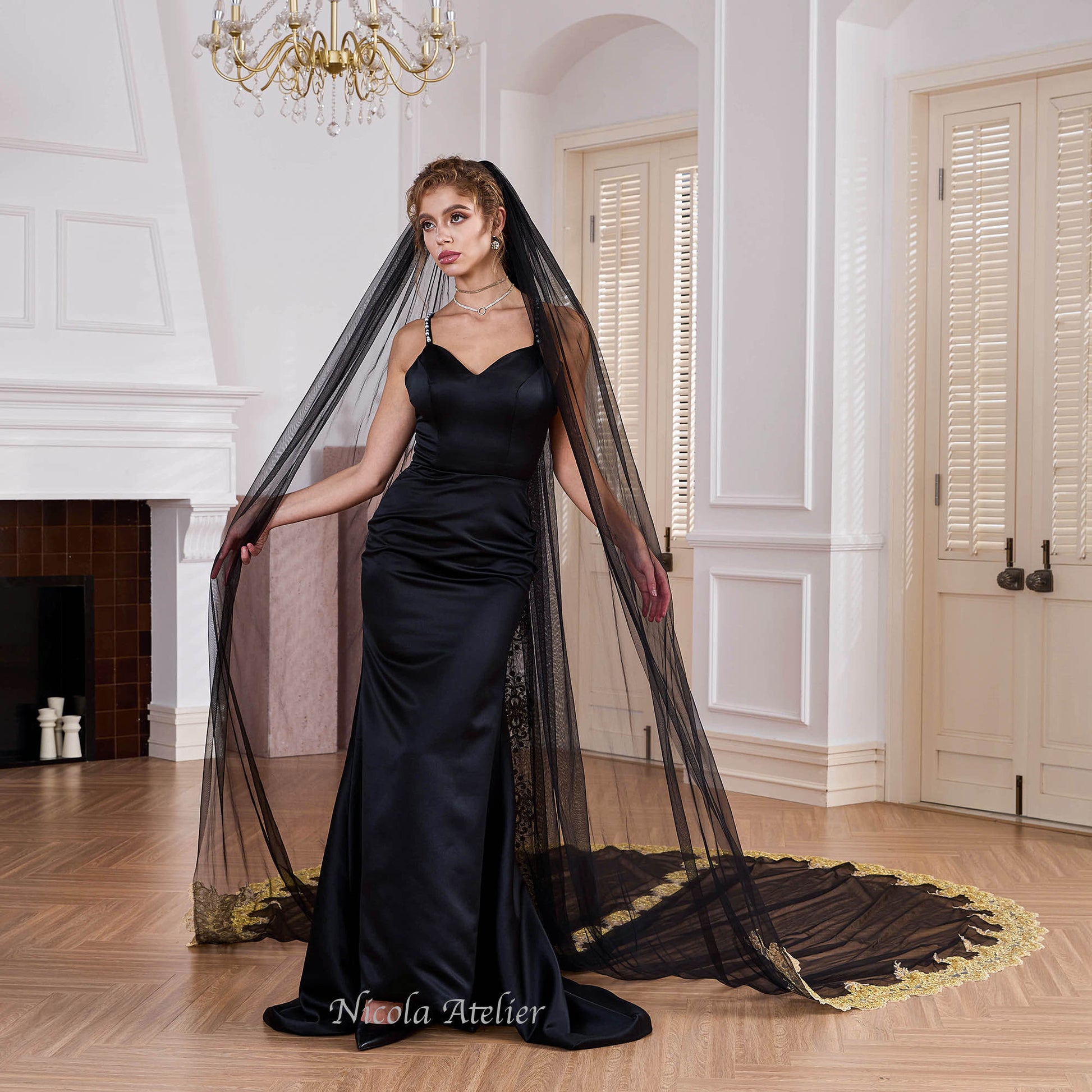 Bride wearing sheer black tulle veil draped over shoulders in indoor venue Nicola Xu Atelier