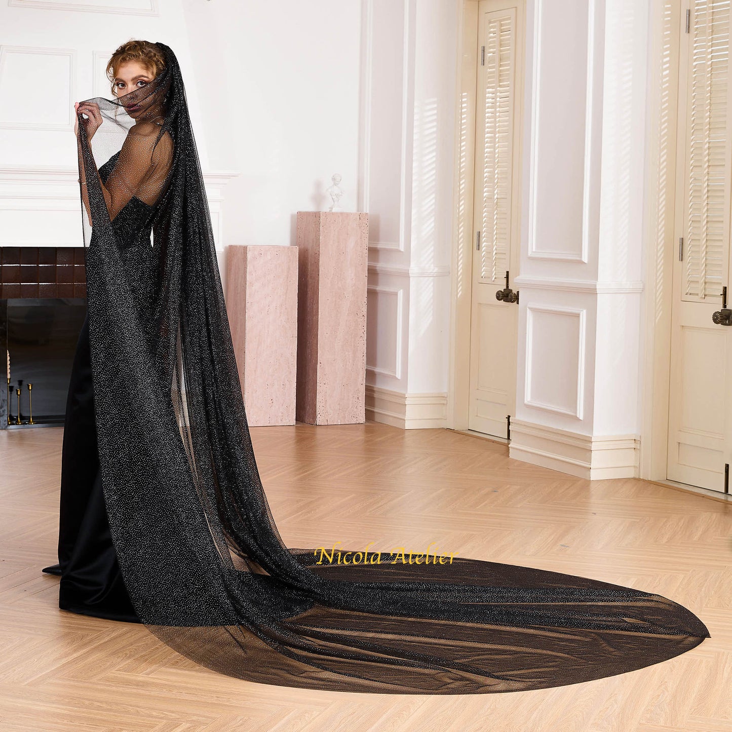 Long cathedral train of a black shimmering bridal veil sweeping across a wooden floor by Nicola Xu Atelier