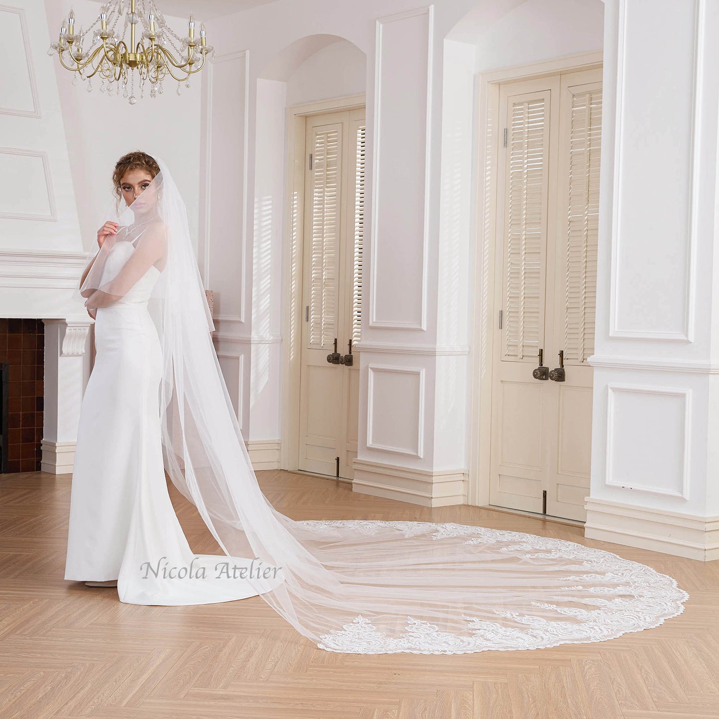 Side profile of bride showcasing the 3-meter wide cathedral lace train Nicola Xu Atelier.