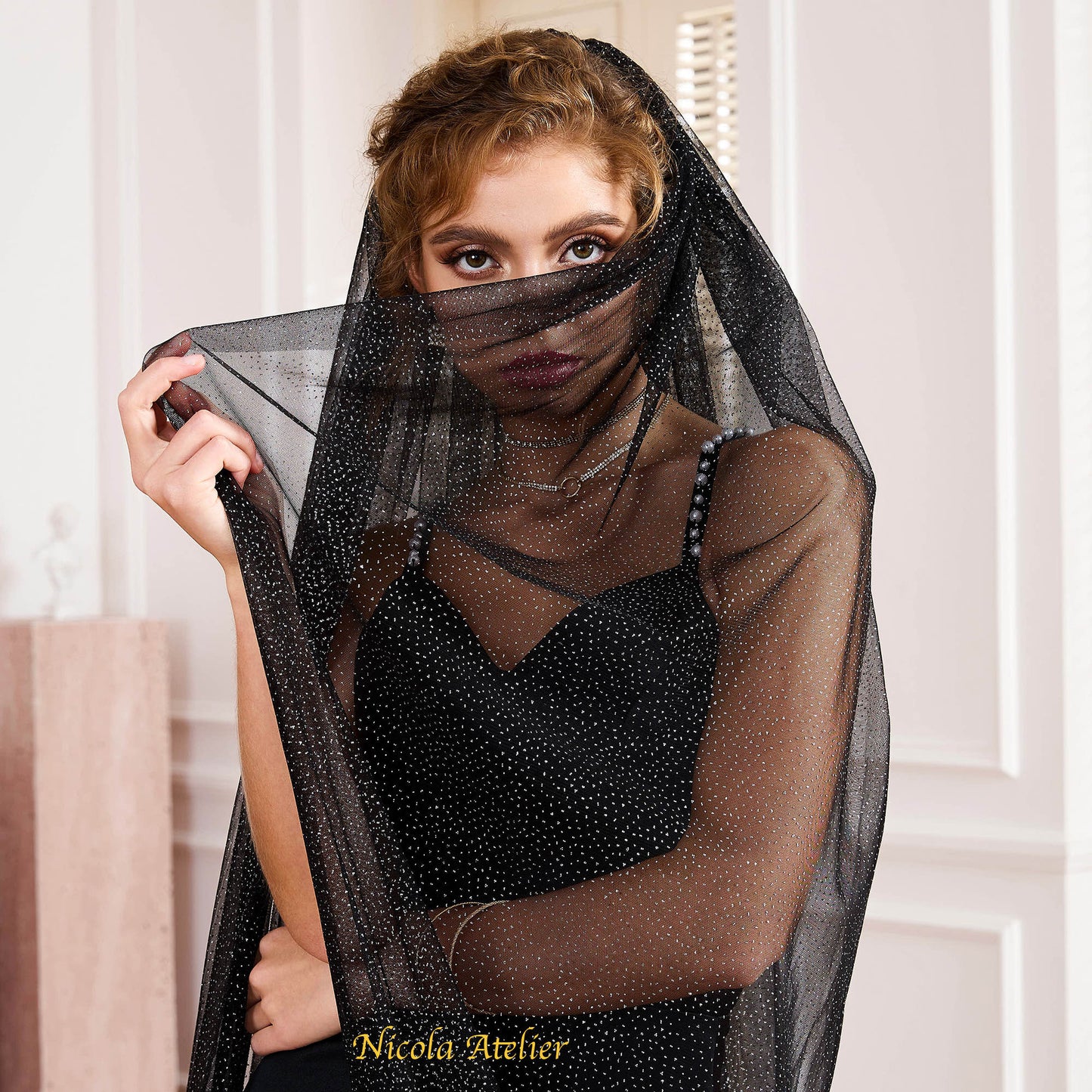 Close-up of black mesh veil with fine silver glitter delicately covering the face by Nicola Xu Atelier.